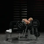 Hammer Strength Plate-loaded glute machine with angled foot platform and band pegs