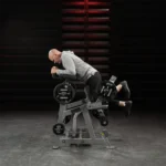 Hammer Strength Plate-loaded kneeling leg curl with pivoting knee cradle and storage horns