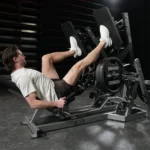 Hammer Strength Plate-loaded squat press with articulating foot platforms and dual-purpose handles