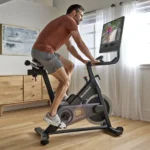 NordicTrack studio bike with hybrid pedals and dumbbells