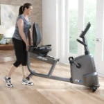 Recumbent exercise bike with mesh back seat and side-mounted handlebars