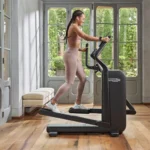 Technogym Compact side view of compact foldable elliptical trainer with device holder
