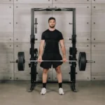 Technogym Personal Strength Home power rack bundle with barbell, dumbbell bars, plates, and clamps