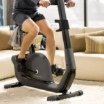 Upright home exercise bike with ergonomic grips and adjustable seat